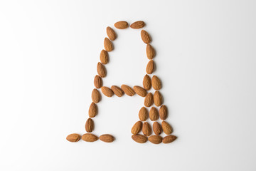 Nuts, almond, tasty and healthy food with lots of vitamins. Almond nuts placed in form of letter A. Concept design