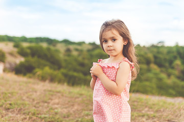 Fototapeta na wymiar Little girl holding a flower