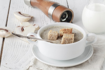 Homemade mushroom cream soup on the wooden table