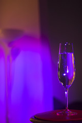 Champagne glass in disco party bar