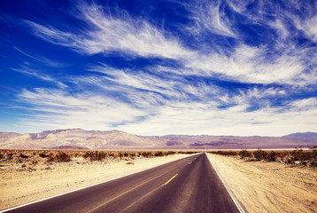 Fototapeta na wymiar Desert road, color toning applied, travel concept picture.