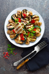 Salad with grilled vegetables and mushrooms. Vegetable salad with grilled champignons. Grilled salad on plate
