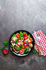 Salad with fresh and grilled vegetables and mushrooms. Vegetable salad with grilled champignons. Vegetable salad on plate. Healthy vegetarian food