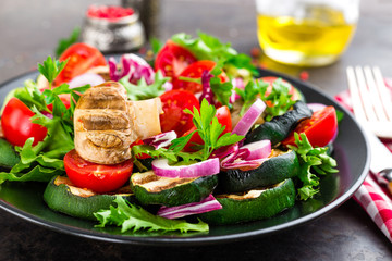 Salad with fresh and grilled vegetables and mushrooms. Vegetable salad with grilled champignons. Vegetable salad on plate. Healthy vegetarian food