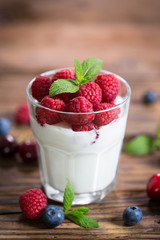 Fresh fruit yogurt with fresh berries and peaches