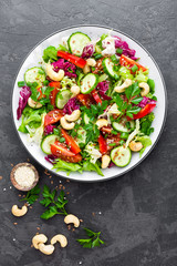 Vegetable salad. Fresh salad with vegetables and nuts. Vegetable salad on plate. Healthy vegetarian food