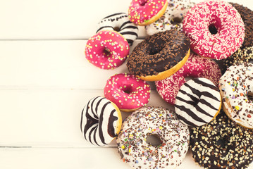 Colorful glazed donuts with sprinkles 