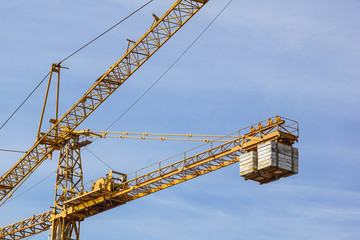 The elevating crane against the dark blue sky.