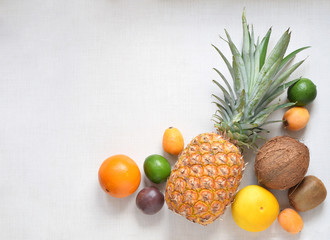 Tropical fruits variety top view on white background with place for text