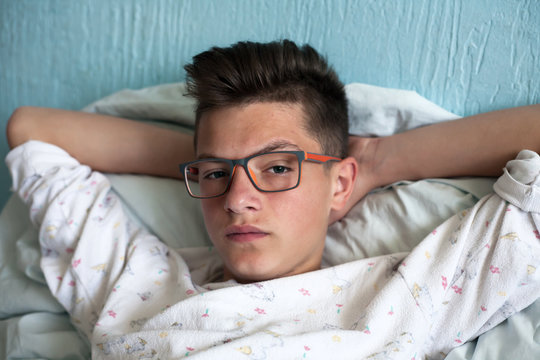 lonely teenager lying in bed
