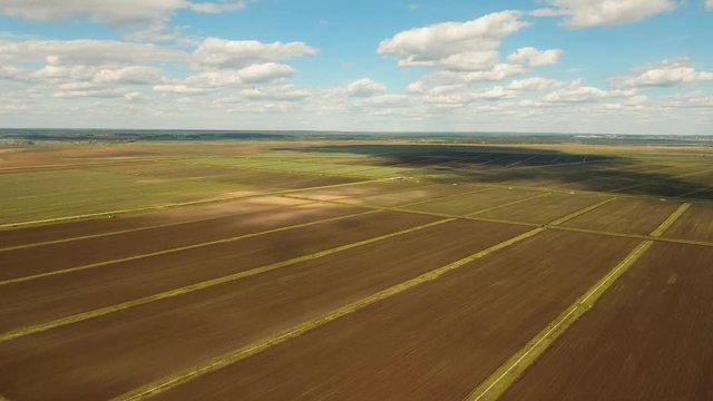 Aerial view of agricultural, cultivated fields. Agricultural landscape.Irrigated farmland. 4K, flying video, aerial footage