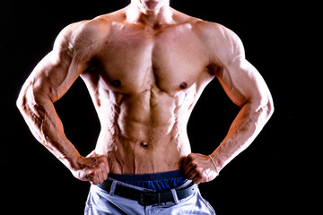 Front view body of muscular biceps sportsman or bodybuilder isolate on black background