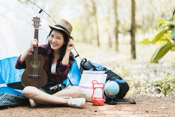 Fototapeta na wymiar asian woman travel camp in forest with happiness and joyful vacation