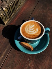 Delicious cappuccino coffee in a blue mug
