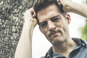 Obraz premium stress and serious caucasian man with problem and hand touch head no way out