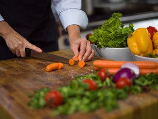 chef hands cutting carrots