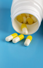 Various pills bottles and white round pills