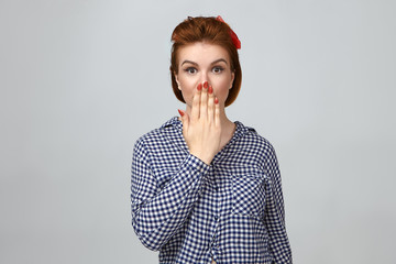 Omg. Cute girl expressing full disbelief, covering mouth. Picture of astonished beautiful young...