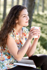 beautiful girl in the forest, bright sunlight around, green grass and trees