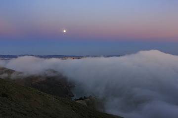 Night moon rise and sea cloud of the famous and beautiful Golden Gate Bridge