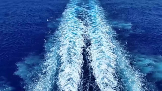 Wake of a cruise ship and blue caribbean water.