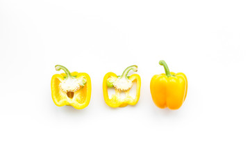 Layout of yellow sweet bell pepper slices on white background top view copy space