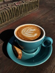 Delicious cappuccino coffee in a blue mug 