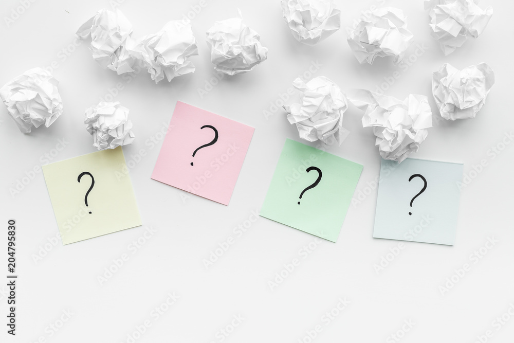 Poster faq concept. question mark on sticky notes near crumpled paper on white background top view copy spa