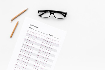 Exam sheet on white table flat lay space for text. Education concept