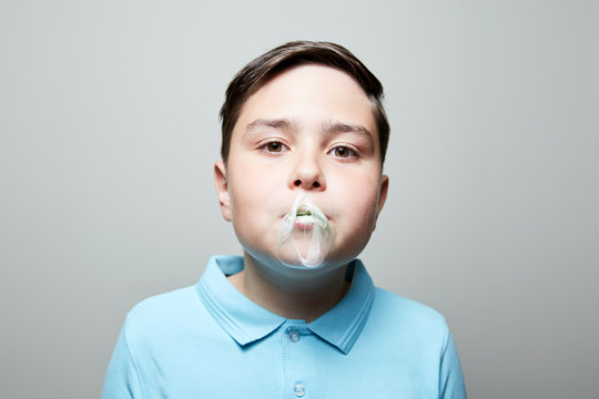 kid blowing bubble gum