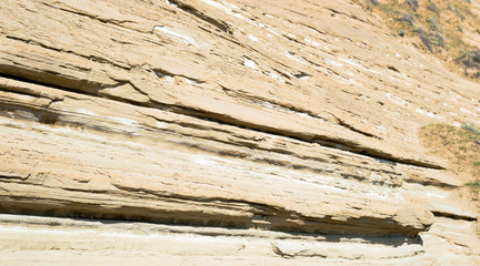 Layers of clay-sandy rock formed by weathering