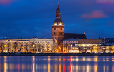 Fototapeta premium Historical building of Riga Dome Cathedral and Daugava river at night , Latvia.