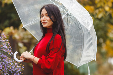 Cheerful young woman with umbrella
