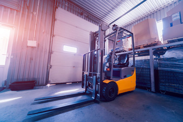 Forklift loader. Pallet stacker truck equipment at warehouse