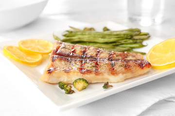 Plate with tasty fish, closeup