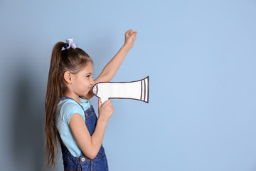 Cute little girl with paper megaphone against color background