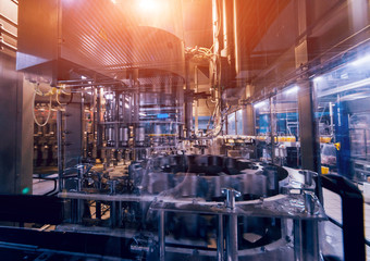 Beverage factory interior. Conveyor with bottles for juice or water. Equipments