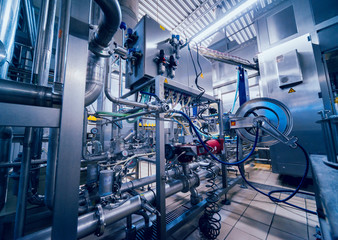 Modern interior of a brewery. Barrels and pipes. Factory interior.