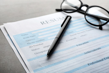 Resume forms and glasses on table, closeup. Job interview