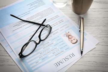 Resume forms and glasses on table. Job interview