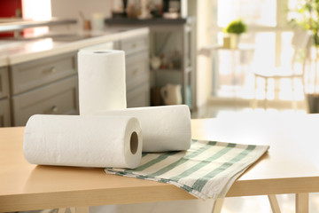 Rolls of paper towels and dishcloth on table indoors