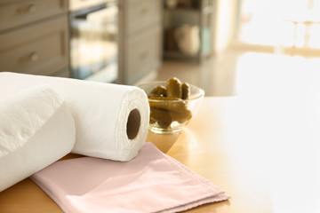 Rolls of paper towels on kitchen table