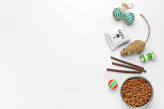 Flat lay composition with cat accessories and food on white background