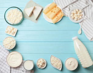 Naklejka na ściany i meble Flat lay composition with different dairy products on wooden background
