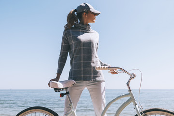 Young woman on a bike ride by the sea