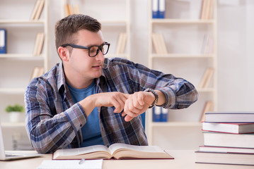 Young student preparing to school exams with books