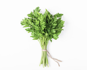 Parsley bunch isolated on white background. Flat lay. Top view. Minimal food concept.