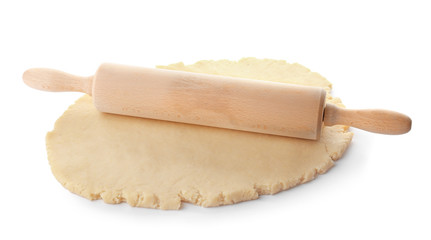 Raw dough and rolling pin on white background