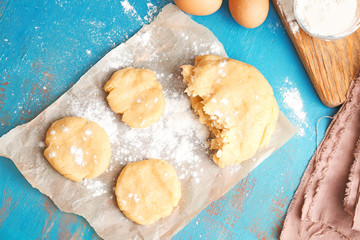 Pieces of fresh raw dough on wooden table