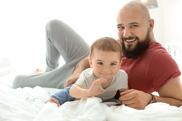 Fototapeta premium Dad and his little son spending time together at home